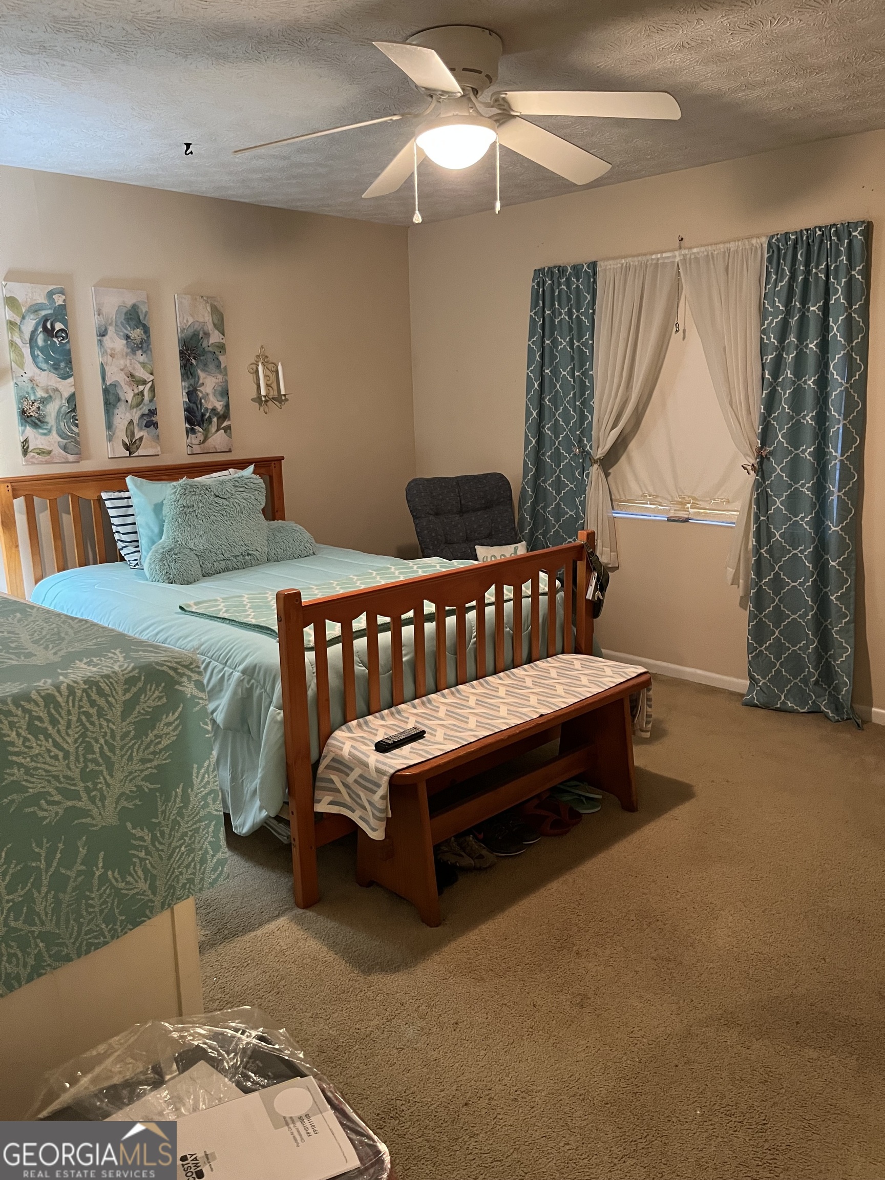 501 Carlton Road, Unit 4C Palmetto, GA 30268 - Photo 9 of 12 a bedroom with a bed and a chandelier