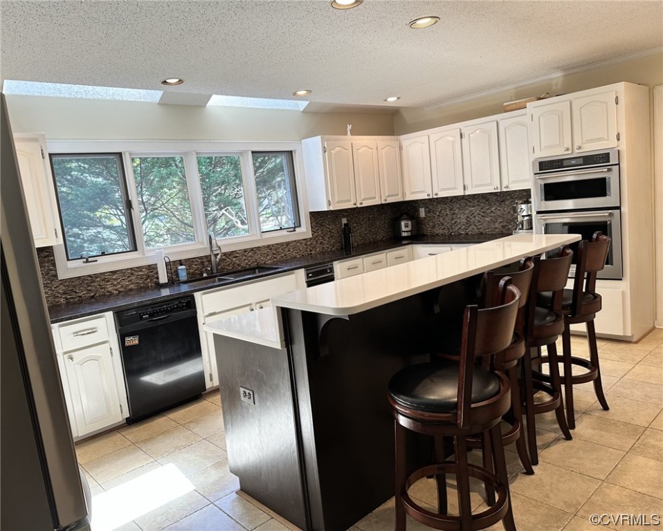 1811 Ducatus Drive Midlothian, VA 23113 - Photo 7 of 24 a kitchen with stainless steel appliances granite countertop a stove a sink a microwave a refrigerator and cabinets