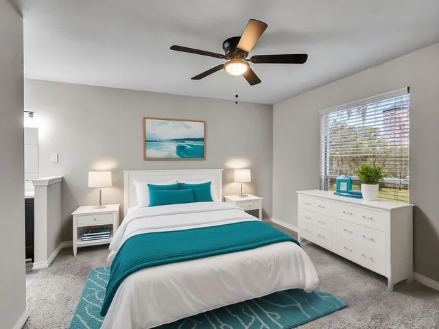 a bedroom with a large bed and a window