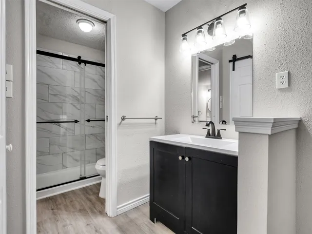 a bathroom with a shower sink and mirror