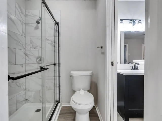 a bathroom with a toilet sink and shower