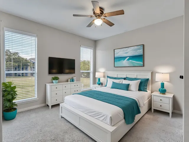 a bedroom with a bed a flat screen tv and a couch