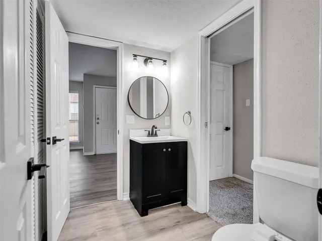 a bathroom with a sink a toilet and a mirror