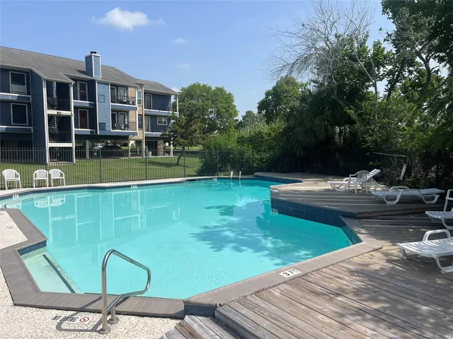 a view of swimming pool with a lounge chair