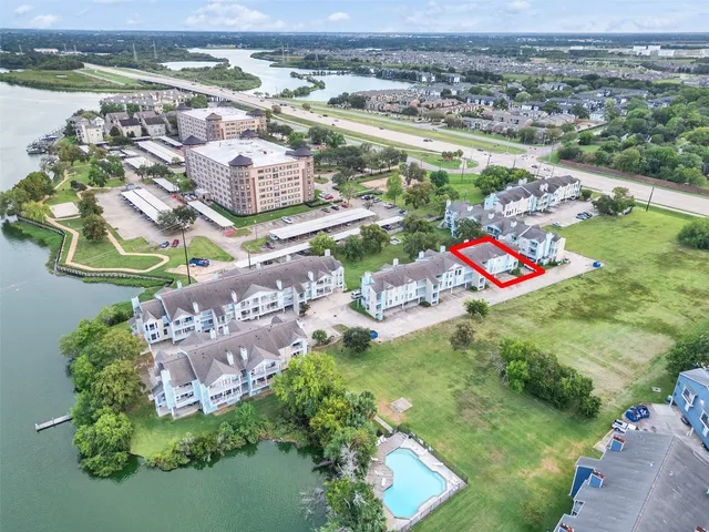 an aerial view of residential houses with outdoor space and river
