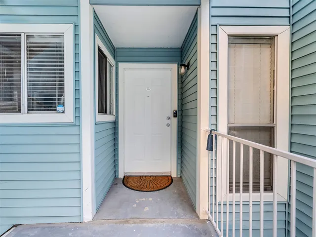 a view of a house with a door and wooden floor