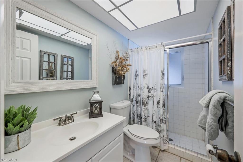 289 Burning Tree Drive Naples, FL 34105 - Photo 19 of 36 a bathroom with a sink toilet and shower