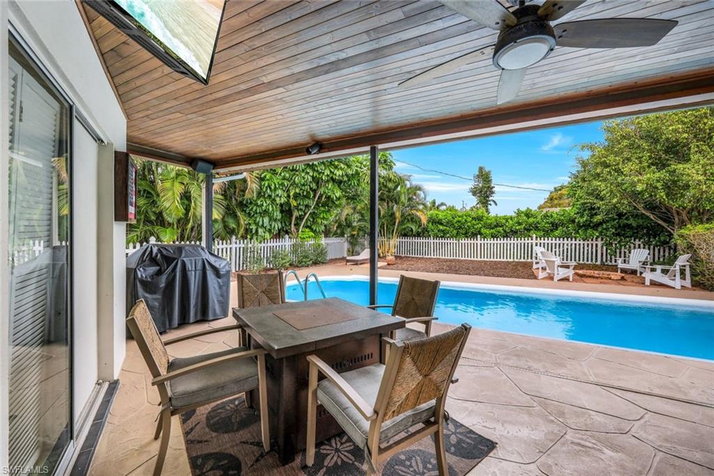 289 Burning Tree Drive Naples, FL 34105 - Photo 22 of 36 a view of a patio with a table chairs and a patio