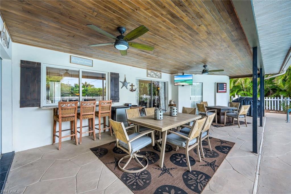 289 Burning Tree Drive Naples, FL 34105 - Photo 24 of 36 a view of a dining room with furniture window and outside view