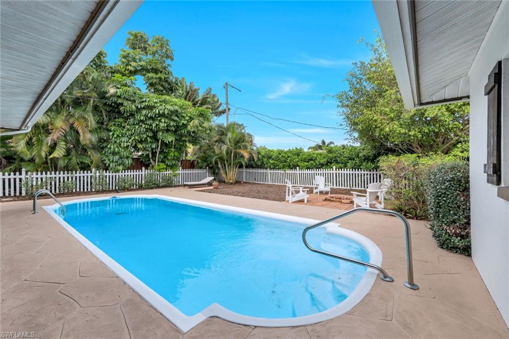 289 Burning Tree Drive Naples, FL 34105 - Photo 25 of 36 a view of a swimming pool with a patio