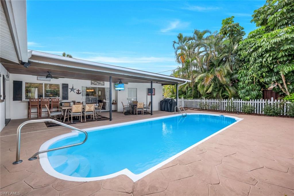 289 Burning Tree Drive Naples, FL 34105 - Photo 27 of 36 a view of a swimming pool with outdoor seating