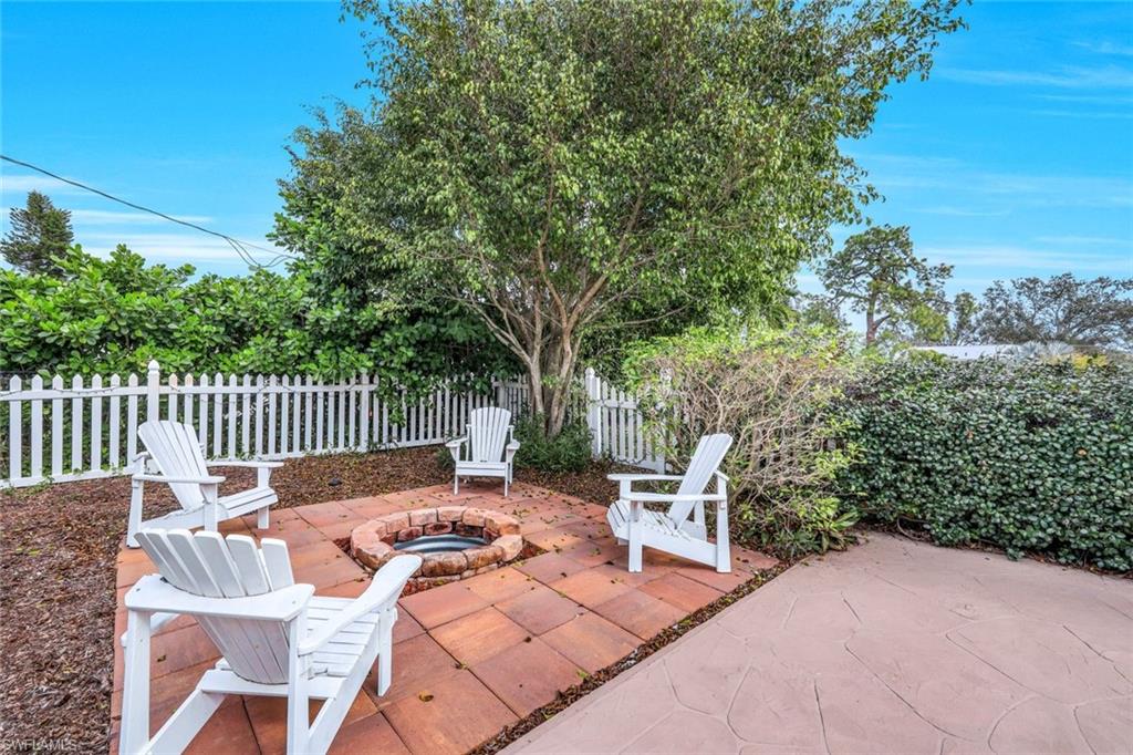289 Burning Tree Drive Naples, FL 34105 - Photo 29 of 36 a view of a patio with a table