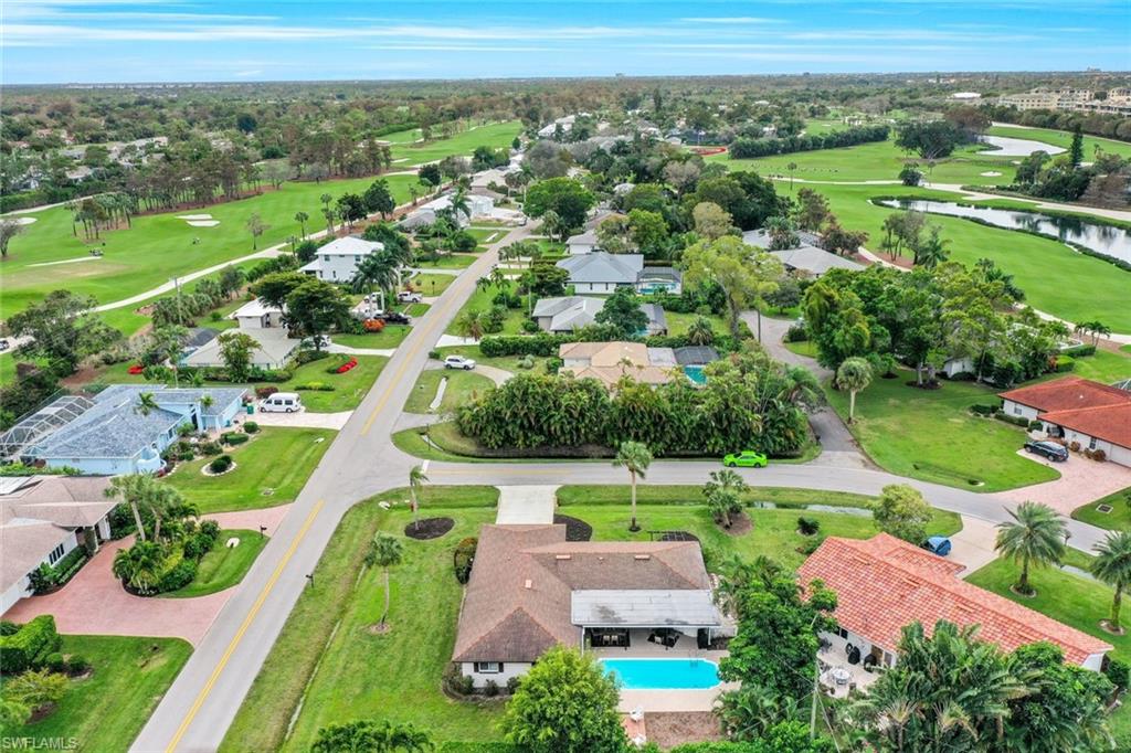 289 Burning Tree Drive Naples, FL 34105 - Photo 31 of 36 an aerial view of a city with mountains