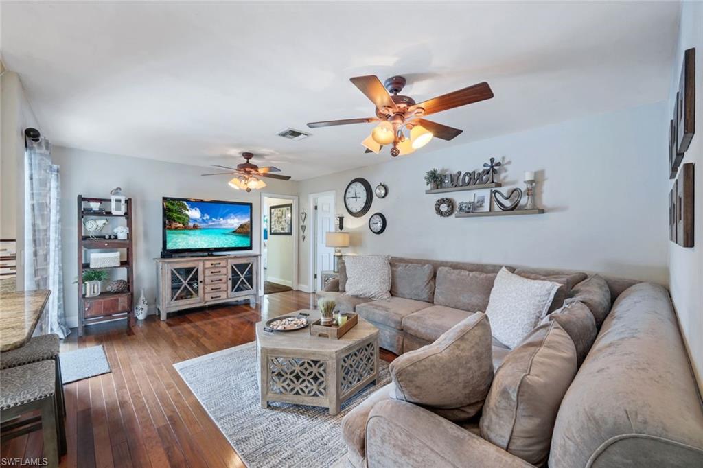 289 Burning Tree Drive Naples, FL 34105 - Photo 5 of 36 a living room with furniture and wooden floor