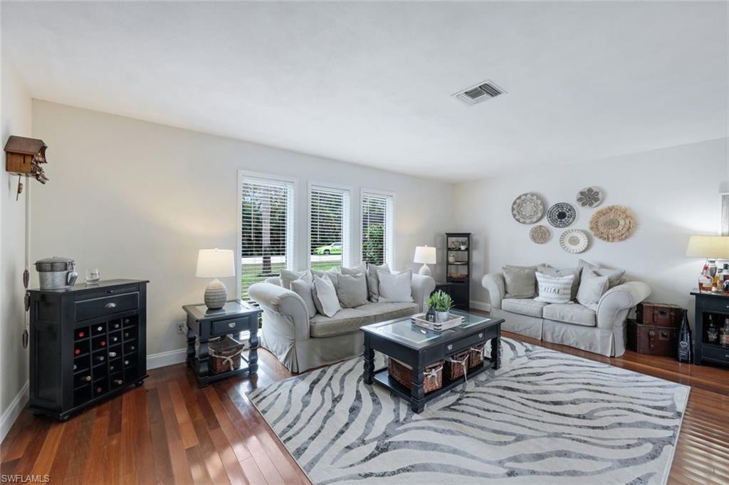 289 Burning Tree Drive Naples, FL 34105 - Photo 6 of 36 a living room with furniture and wooden floor