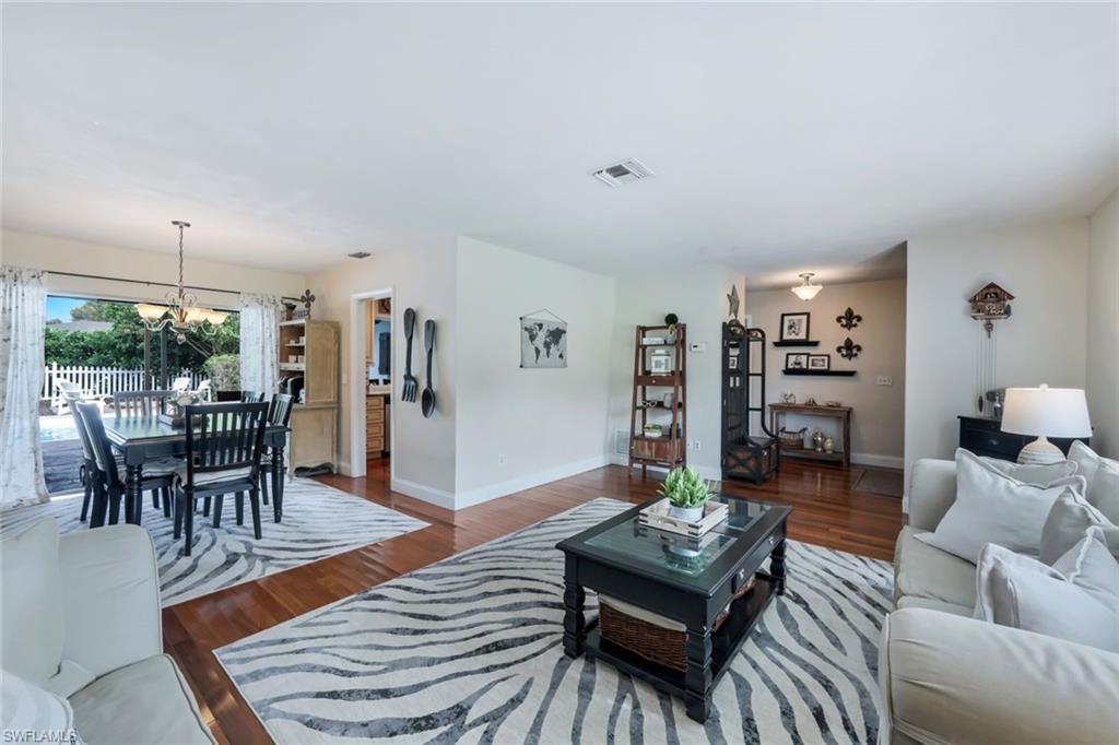 289 Burning Tree Drive Naples, FL 34105 - Photo 7 of 36 a living room with furniture and wooden floor