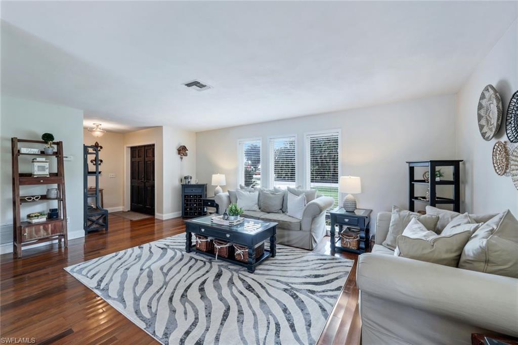 289 Burning Tree Drive Naples, FL 34105 - Photo 8 of 36 a living room with furniture and a wooden floor
