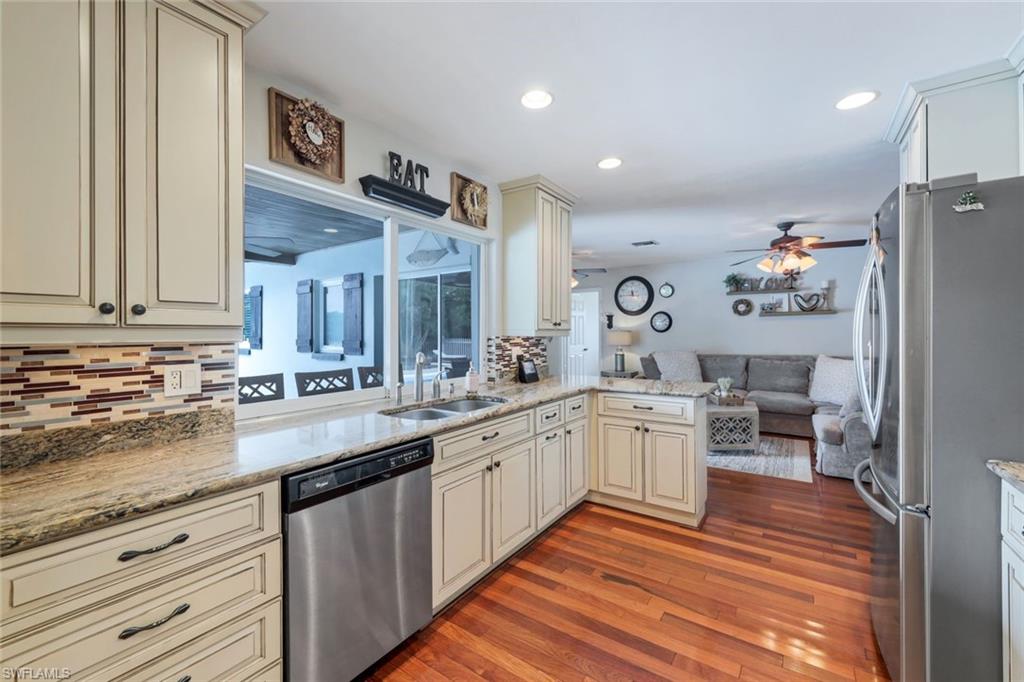289 Burning Tree Drive Naples, FL 34105 - Photo 9 of 36 a large kitchen with granite countertop lots of counter top space