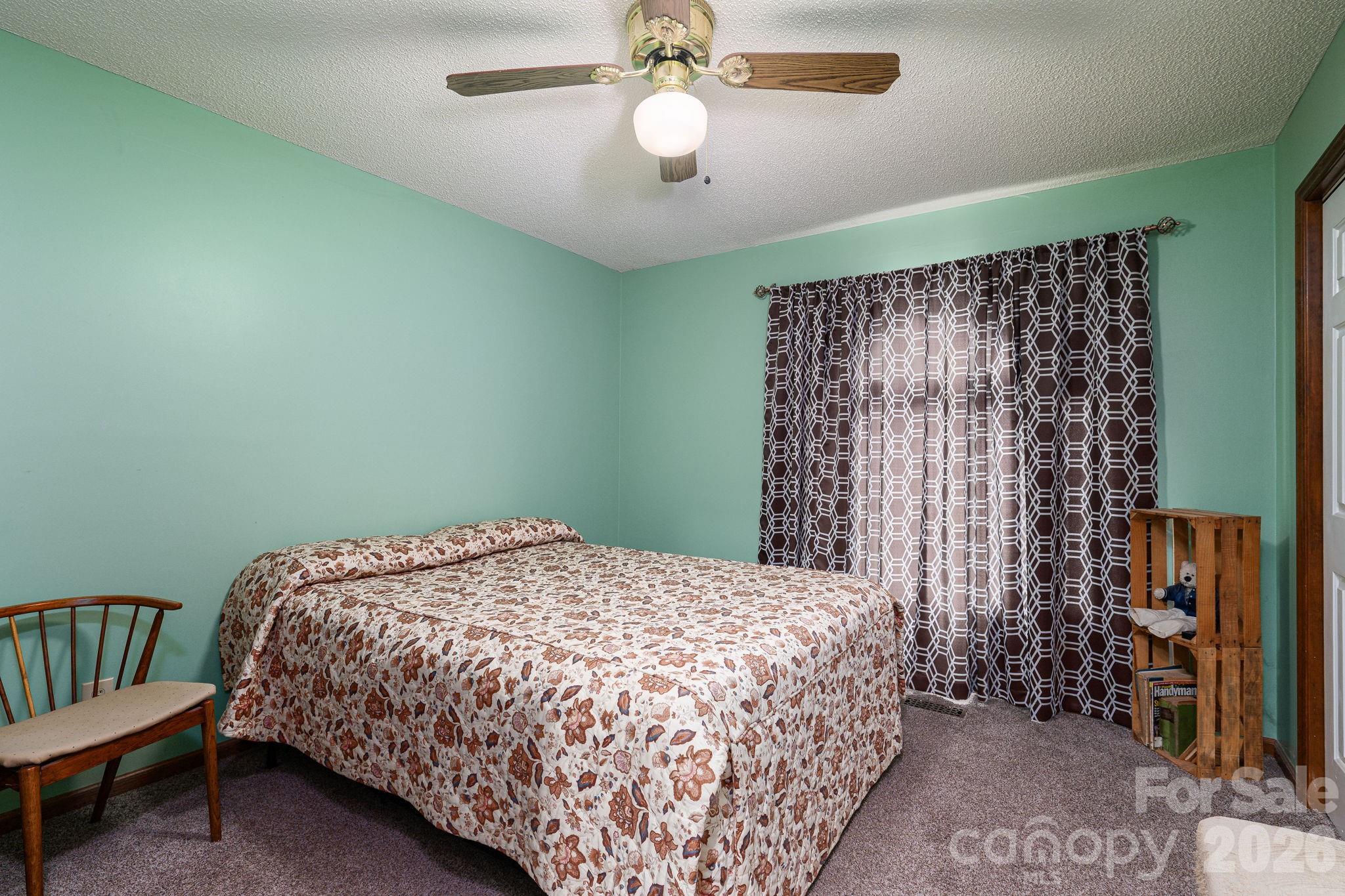 3815 Wildcherry Road Shelby, NC 28150 - Photo 21 of 33 a bedroom with a bed and a chandelier