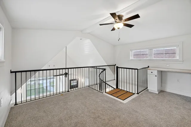 a view of a hallway with a ceiling fan