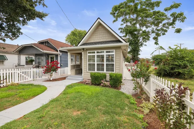 a front view of a house with a yard and porch