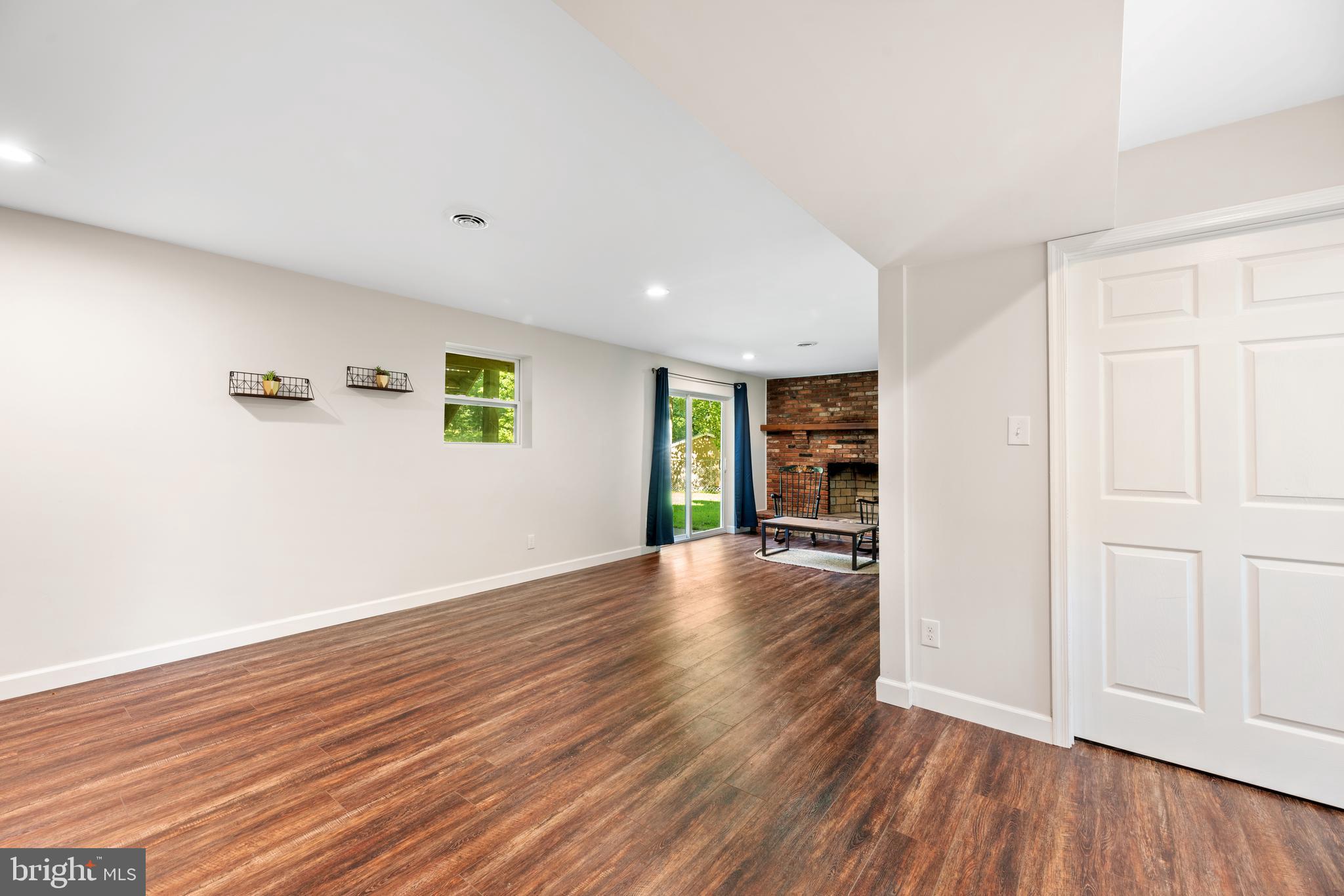 5756 Stephen Reid Road Huntingtown, MD 20639 - Photo 31 of 42 an empty room with wooden floor and windows