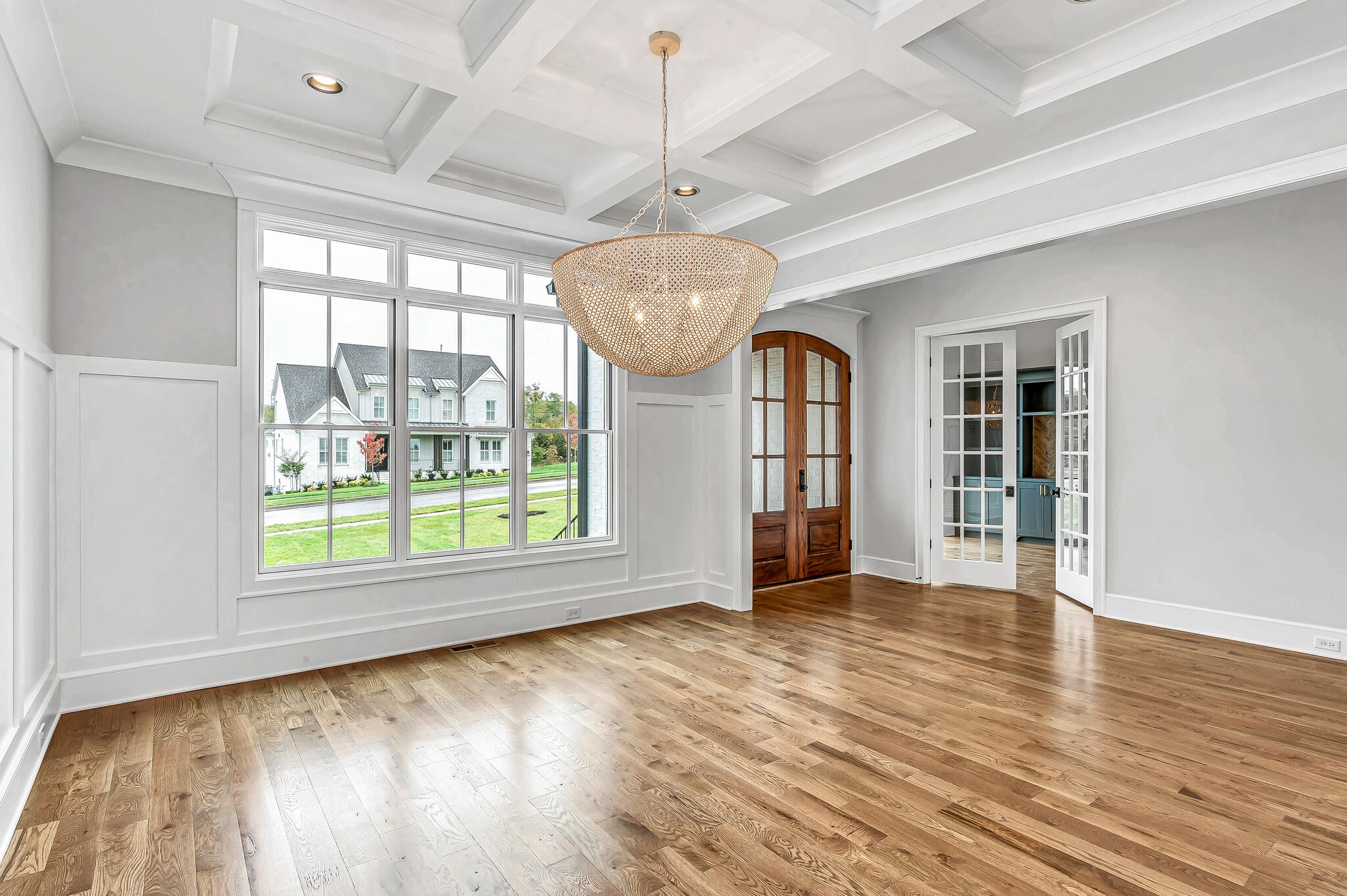 1891 Traditions Circle Franklin, TN 37067 - Photo 13 of 50 an empty room with wooden floor chandelier and windows