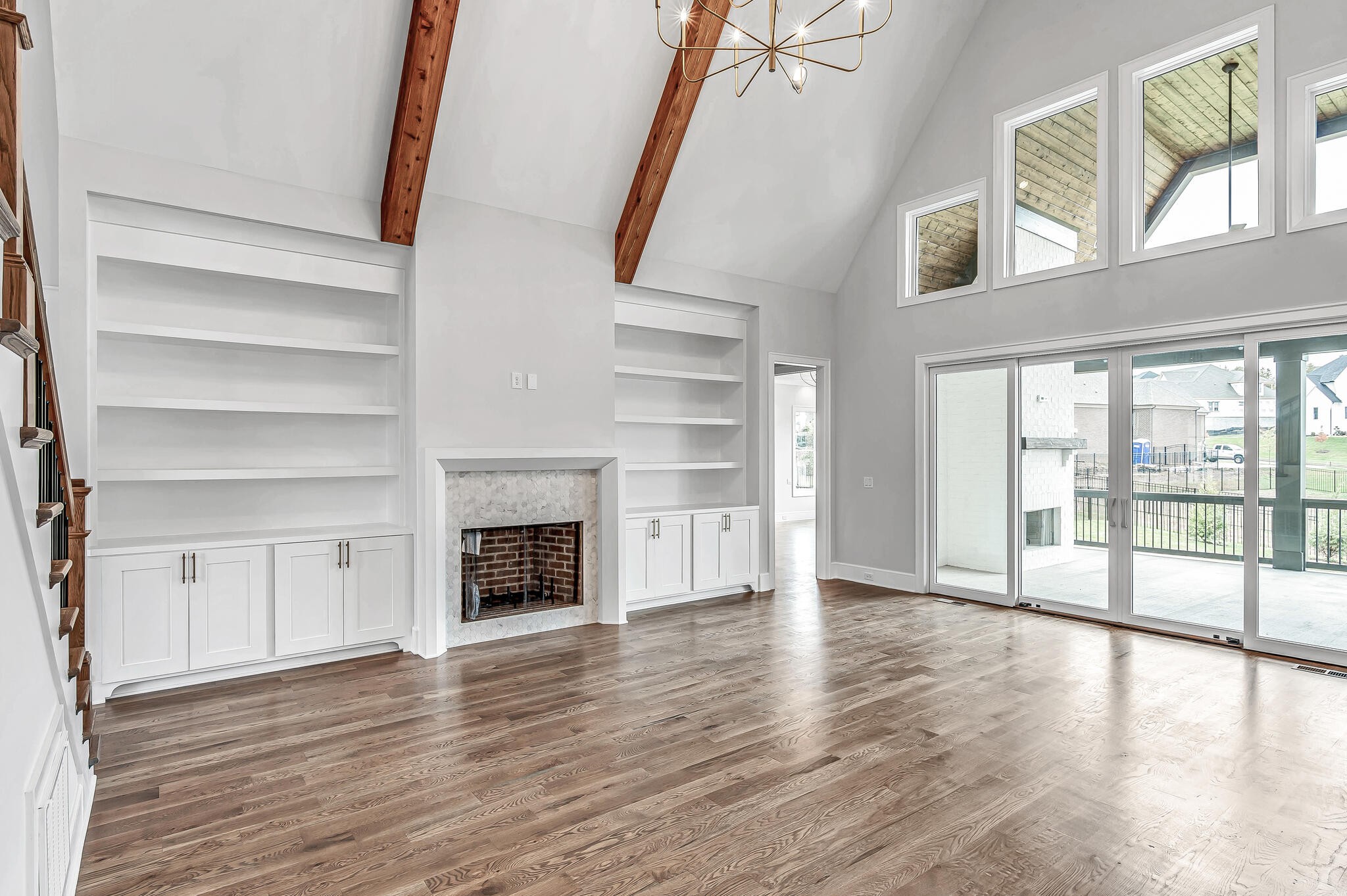 1891 Traditions Circle Franklin, TN 37067 - Photo 14 of 50 an empty room with wooden floor fireplace and windows