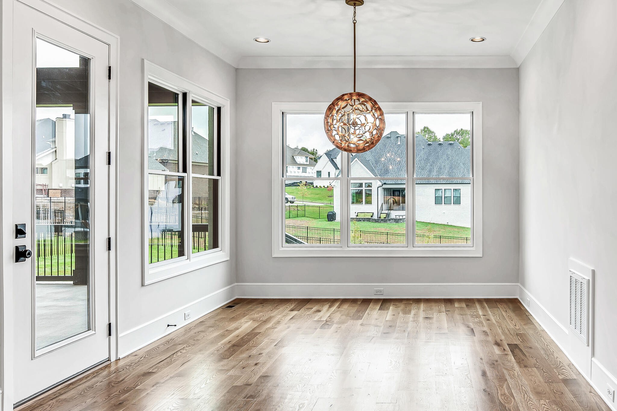 1891 Traditions Circle Franklin, TN 37067 - Photo 23 of 50 a view of an empty room with wooden floor and a window