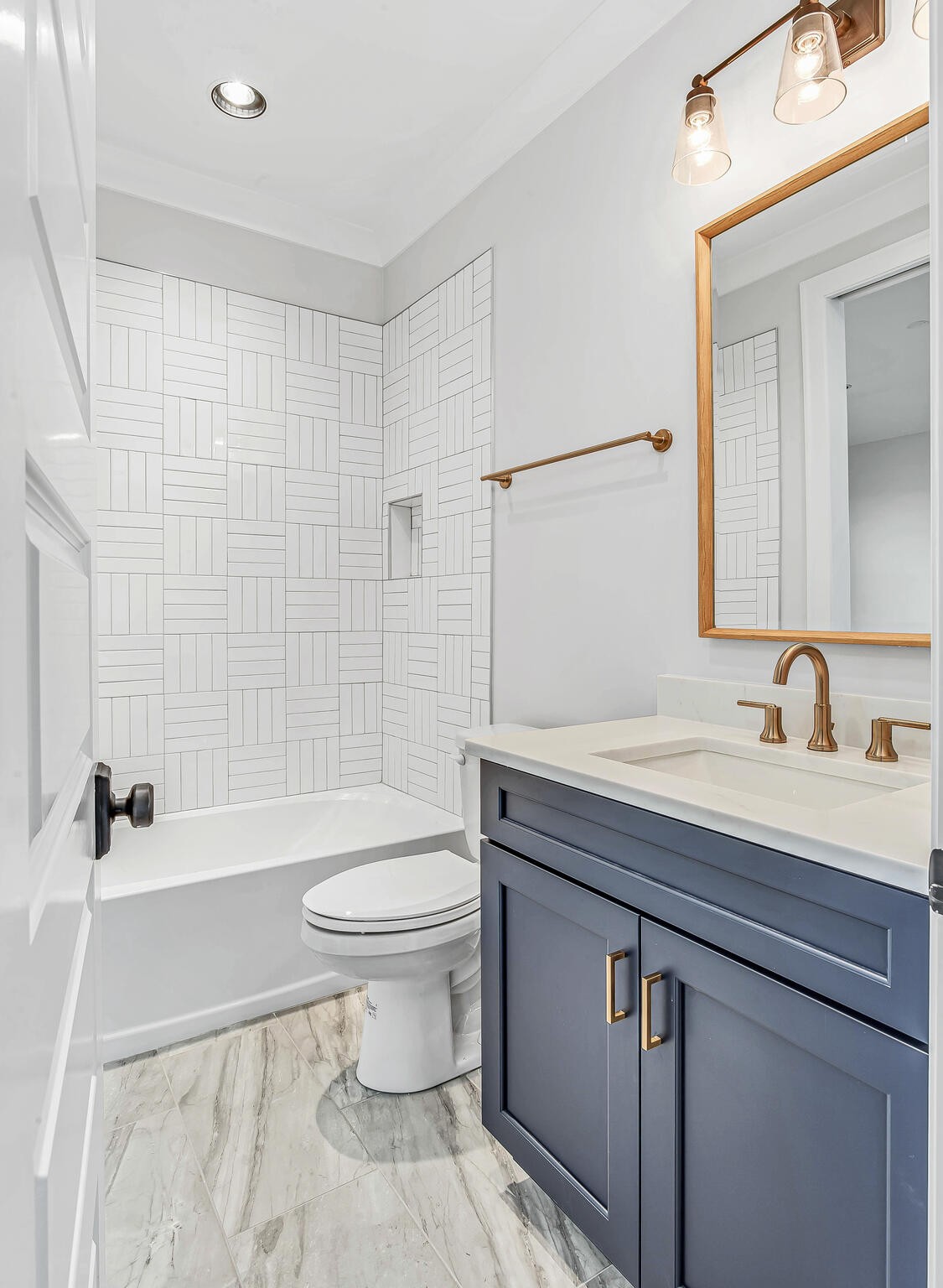 1891 Traditions Circle Franklin, TN 37067 - Photo 45 of 50 a bathroom with a granite countertop toilet a sink a mirror and bathtub