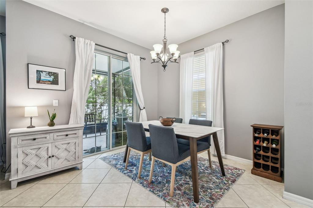 7001 Interbay Boulevard, Unit 134 Tampa, FL 33616 - Photo 16 of 84 a dining room with furniture a chandelier and window