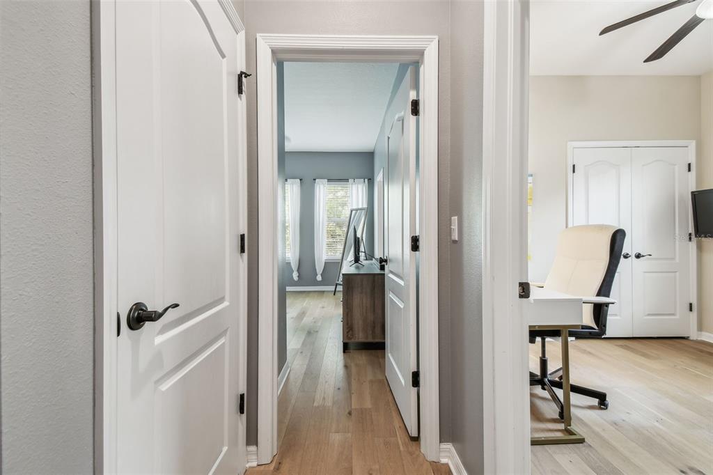 7001 Interbay Boulevard, Unit 134 Tampa, FL 33616 - Photo 29 of 84 a view of a hallway with wooden floor and a bathroom
