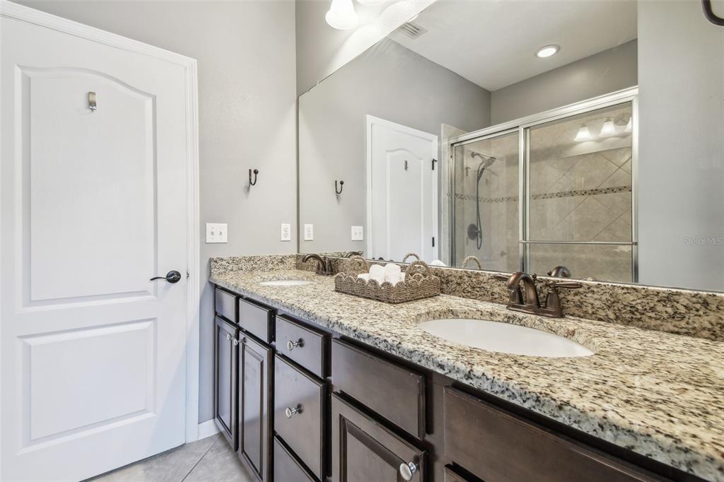 7001 Interbay Boulevard, Unit 134 Tampa, FL 33616 - Photo 35 of 84 a bathroom with a granite countertop sink and a mirror