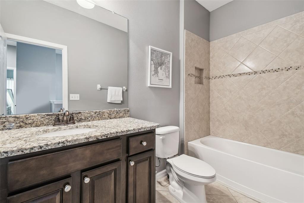 7001 Interbay Boulevard, Unit 134 Tampa, FL 33616 - Photo 44 of 84 a bathroom with a granite countertop toilet sink and mirror
