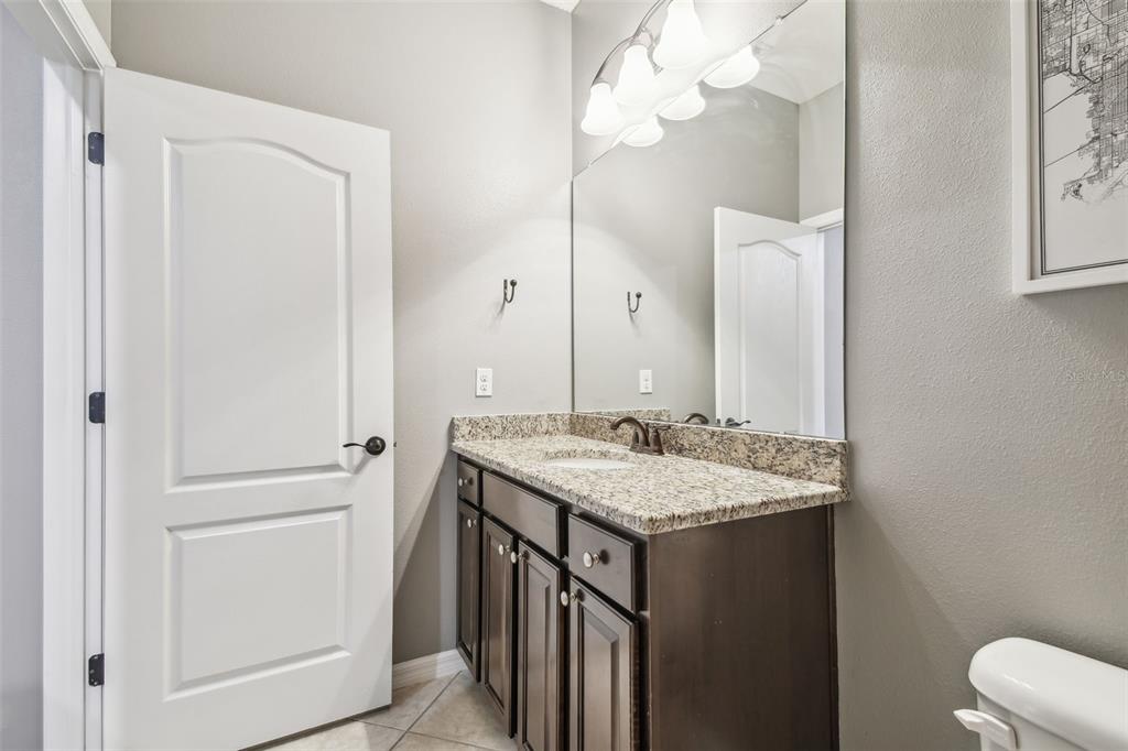 7001 Interbay Boulevard, Unit 134 Tampa, FL 33616 - Photo 45 of 84 a bathroom with a granite countertop sink and a mirror
