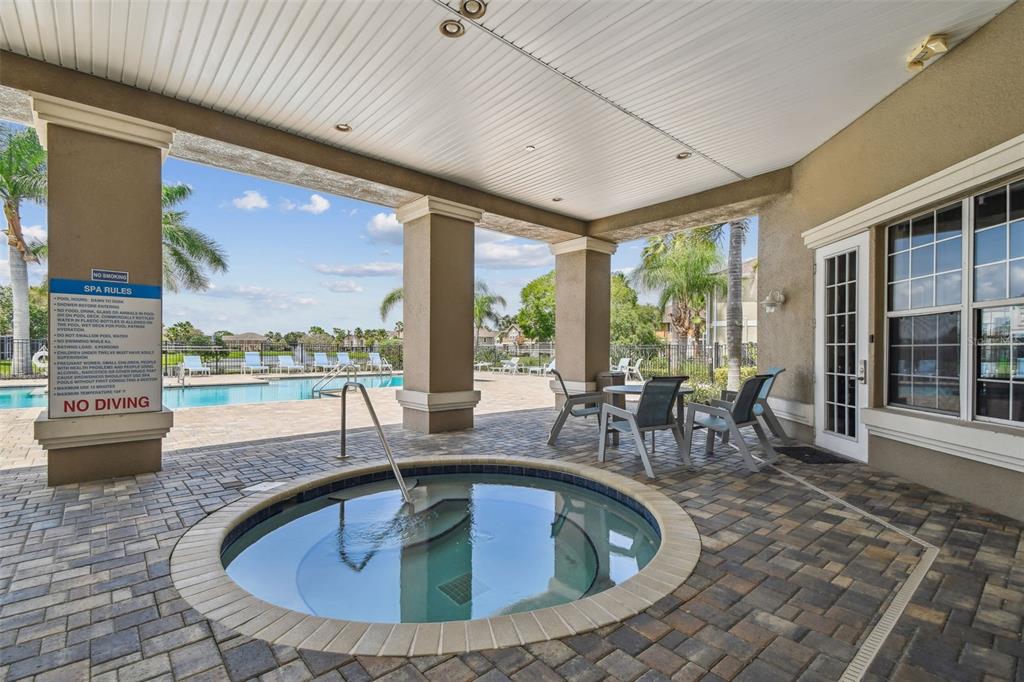 7001 Interbay Boulevard, Unit 134 Tampa, FL 33616 - Photo 66 of 84 a view of a dining room with furniture large windows and wooden floor
