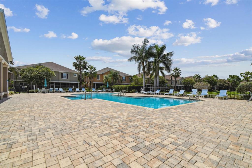 7001 Interbay Boulevard, Unit 134 Tampa, FL 33616 - Photo 75 of 84 a view of swimming pool with seating area and trees in the background