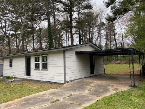 4144 Canby Lane, Unit 36 Decatur, GA 30035 - Photo 1 of 1 a backyard of a house with yard and garage