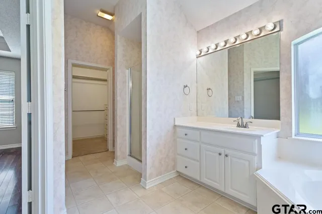 a bathroom with a double vanity sink mirror and double