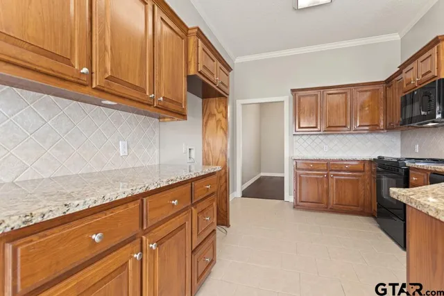 a kitchen with stainless steel appliances granite countertop a stove and a sink