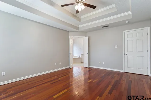 a view of an empty room with wooden floor
