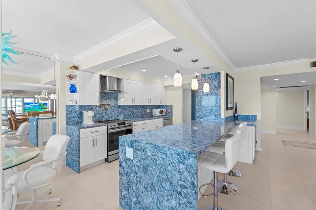 a large white kitchen with a large window