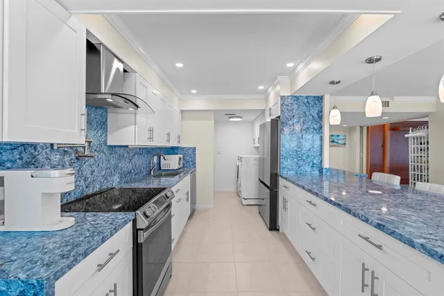 a kitchen with stainless steel appliances granite countertop a sink and a granite counter tops