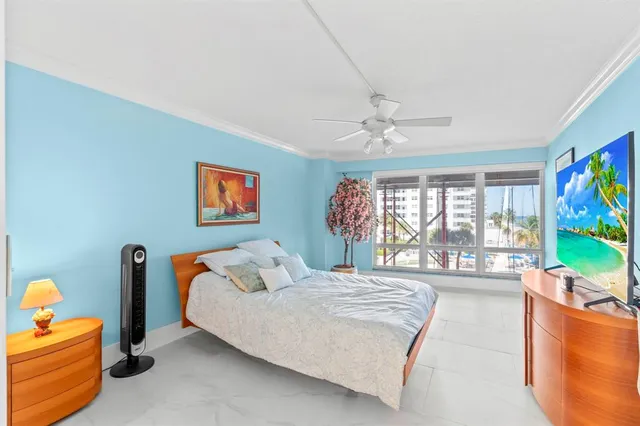 a bedroom with a bed and large windows