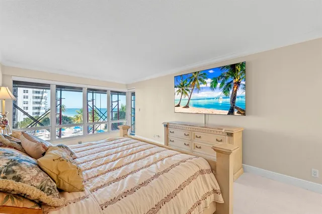 a bedroom with a large bed and a window