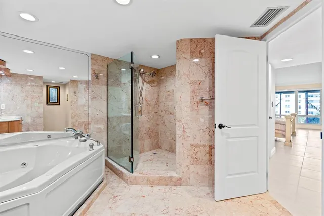 a bathroom with a bathtub and a shower
