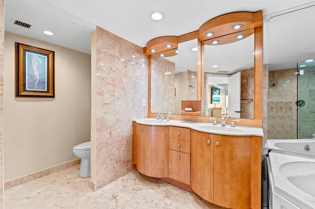 a bathroom with a toilet sink and mirror