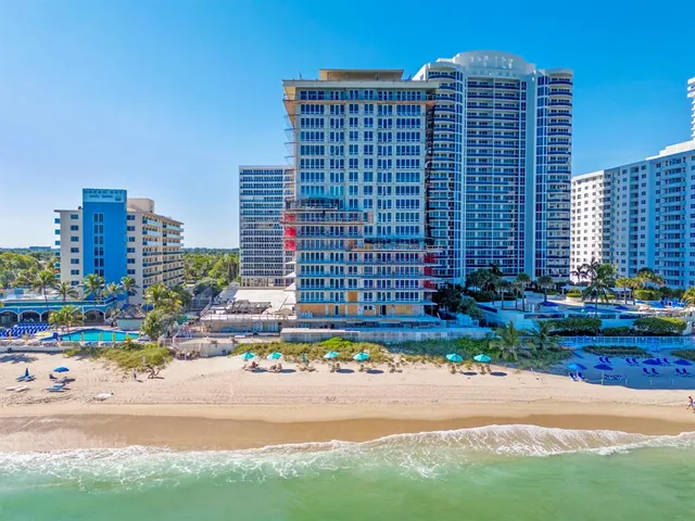 a building view with tall buildings and a yard