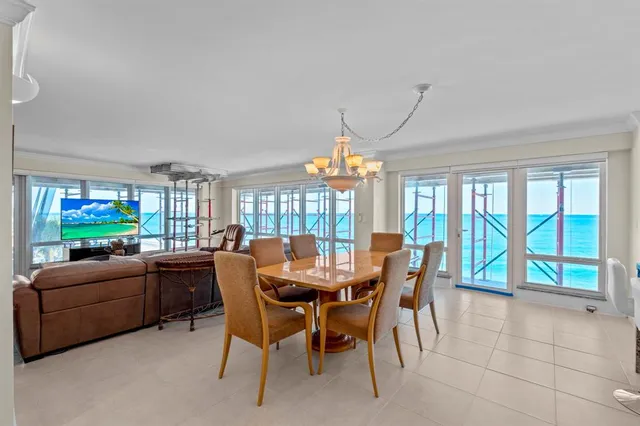 a dining room with furniture a chandelier and fireplace