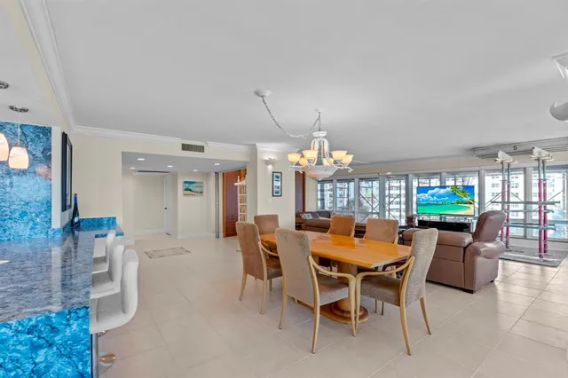 a view of a dining room with furniture and chandelier